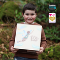 Load image into Gallery viewer, Child holding a book titled 'My Fairy Tooth Fairy' with greenery in the background
