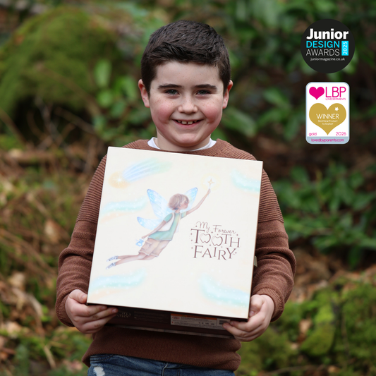 Child holding a book titled 'My Fairy Tooth Fairy' with greenery in the background